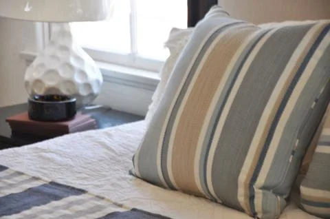 Close up on decorative throw pillow on a bed Stock Photos