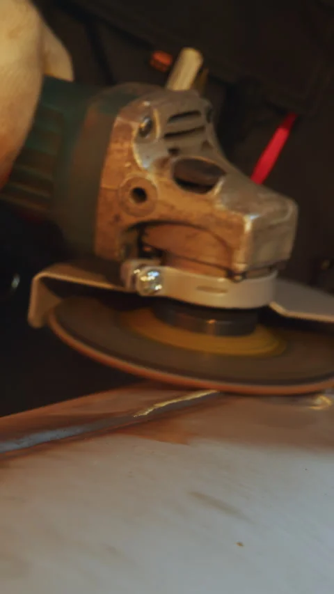 Close Up of a Dedicated Worker Effectively Grinding a Metal Pipe Using a Stock Footage 306072001