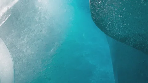 Close up of deep blue ice in an arctic glacier crevasse 스톡 동영상 333205325