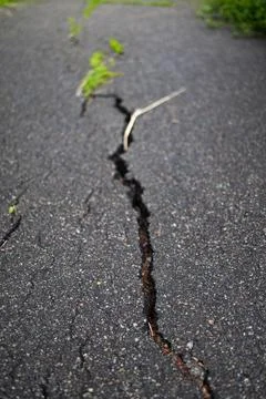 Close up of deep crack on asphalt road texture background. 写真素材