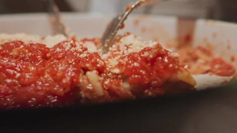 Close up deep dish pizza being cut into slices with utensils in indoor setting Stock Footage 345072860