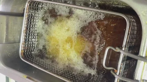 Close-up of deep-fried boiling oil in the restaurant kitchen. The process of Stock Footage 262936855