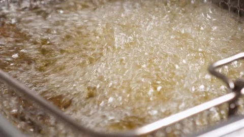 Close-up of deep-fried boiling oil in the restaurant kitchen. Stock Footage 344038769