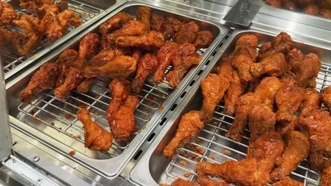 Close up of Deep Fried Chicken Legs Displayed in Metal Tray at Fast Food Buffet Stock Footage 345179564
