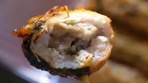 Close Up of Deep Fried Korean Fish Cake Roll wrapped in Seaweed Stock Footage 337374561