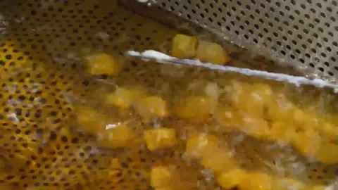Close-up of Deep-Frying Korean Fish Cakes (Eomuk) in Bubbling Oil Stock Footage 337374811