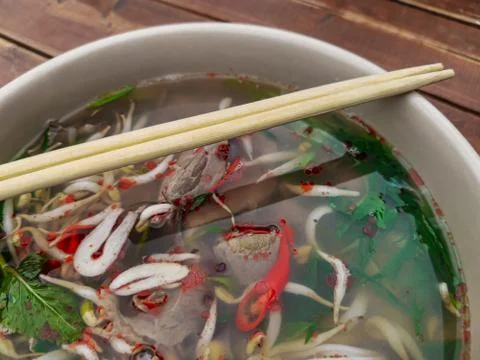 Close-up of a deep plate with Vietnamese pho bo soup and chopsticks Stock Photos