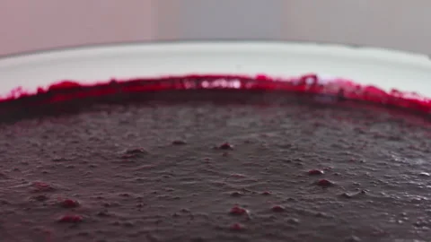 Close up of Deep Purple Berry Puree Simmering in a Large White Cooking Pot Stock Footage 339650442