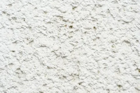 Close-up A deep texture of a white painted porous stone on the facade of the Stock Photos