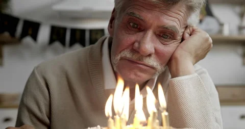 Close-up of deeply disappointed senior man's face sitting alone at kitchen table Video stock 139484086