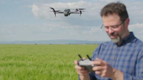 Close up of defocused agronomist operating hovering drone Stock Footage 337120742