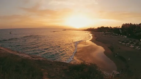 Close up of defocused hand passing in front of the camera with the sunset and th 库存影片 204799706