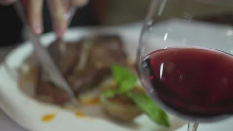 Close up defocused view on handsome brunet blue eyes young man cutting meat beef Video stock 137538251