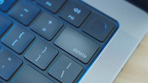 Close up on Delete key as finger clicks it multiple times erasing data or text 動画素材 343772552