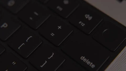 Close-up of delete key on modern black laptop keyboard, symbolizing erase Stock Footage 317951948