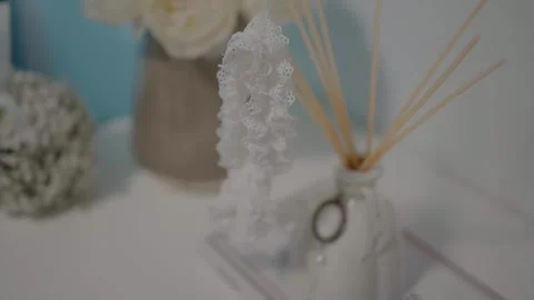 Close-up of a delicate lace garter and aroma diffuser on a bridal table Stock Footage 274336901