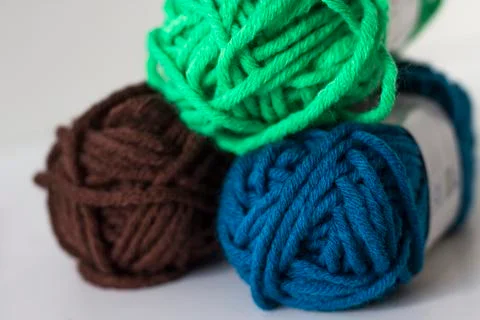Close up of delicate multi colored woollen yarns displayed on white backgroun Stock Photos