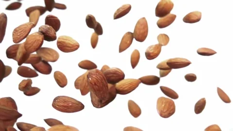 Close-up of delicious almonds falling diagonally on a white background Stock-Footage 255285277