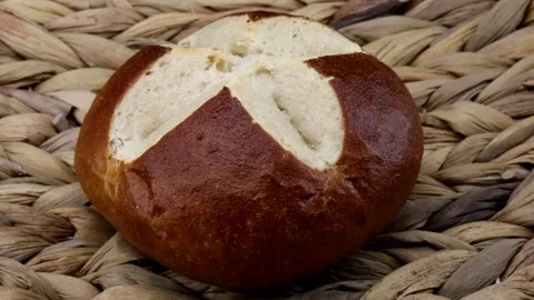 Close-up of a delicious and crispy pretzel roll on a rotating plate Stock Footage 261288254