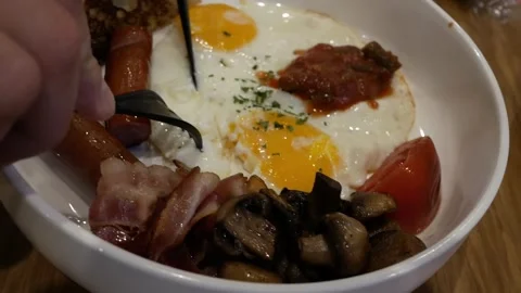 Close-up of delicious and nutritious scrambled eggs with pieces of sausage, mush Stock Footage 295592875