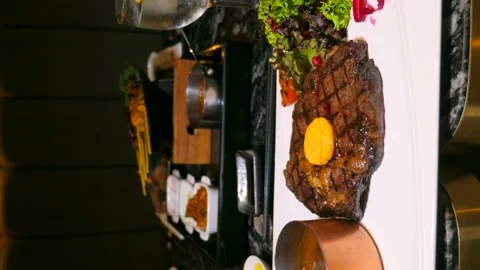 Close-up of delicious beef ribeye steak with butter and vegetables on plate 動画素材 237006973