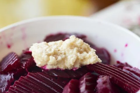 Close-up of a delicious beetroot salad served with a dollop of fresh horser.. Stock Photos