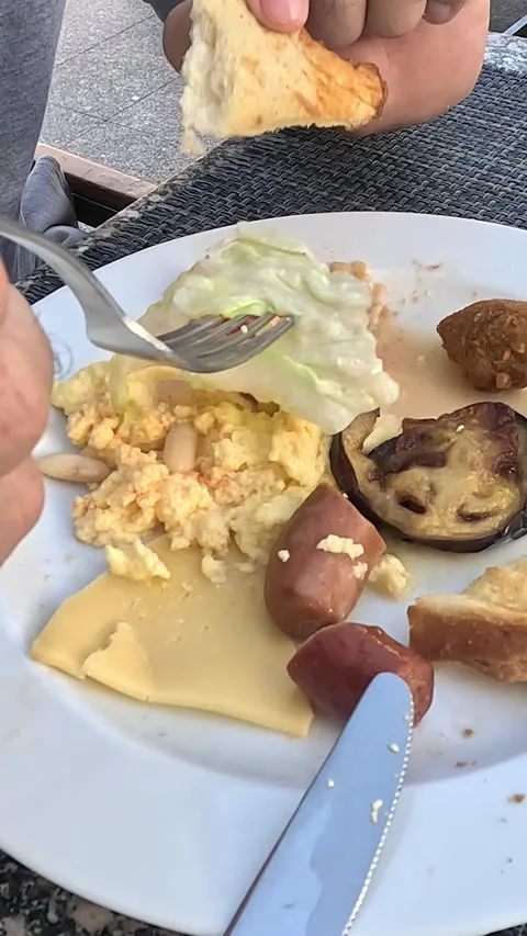 A Close-Up of a Delicious Breakfast Plate Being Enjoyed, Featuring Eggs, Stock Footage 331116342