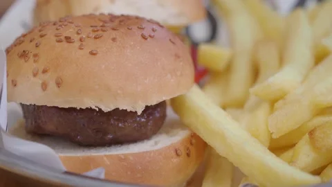 Close up of delicious burger and crispy french fries served in metal plate .. Stock Footage 332097714