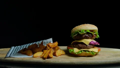 Close up of delicious burger with double cheese and french fries. Black Stock Footage 92488032