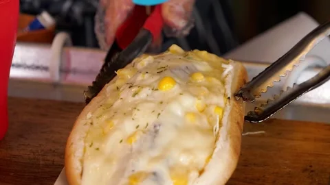 Close-Up of Delicious Cheesy Corn Hot Dog Being Prepared or Served Stock Footage 331954673