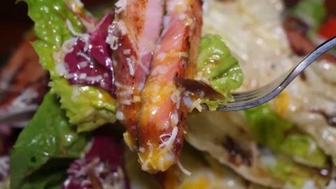 Close-up of a Delicious Chicken and Bacon Caesar Salad with a Fork Lifting a Pie 스톡 동영상 332817745