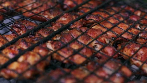 Close-up of delicious chicken wings grilling on a barbecue rack outdoors Stock Footage 340263889