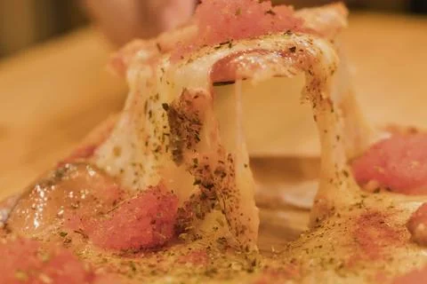 Close up of a delicious dessert with pink toppings and melted cheese Stock Photos