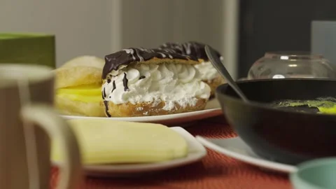 Close-up of Delicious Eclairs with Chocolate and Cream Filling Stock Footage 285369240