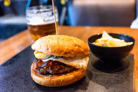 Close-up of delicious fresh hamburger on the table in restaurant. Stock Photos