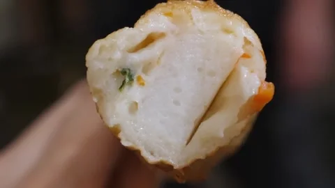 Close up of Delicious Fried Korean Fish Cake Roll (Eomuk) with Vegetable Filling Stock Footage 337373163
