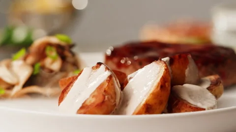 Close up of delicious grilled beef steak medallions served on table with potato Stock Footage 258383133
