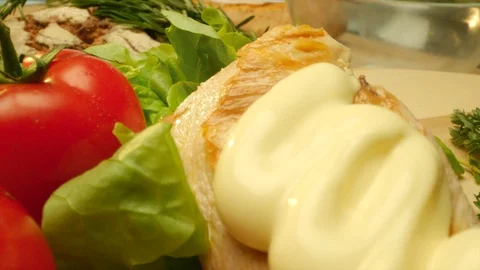 Close up delicious grilled chicken covered with mayonnaise with fresh greens and Stock Footage 107565442