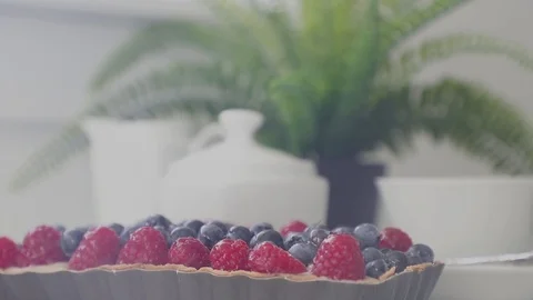 Close-up of delicious home-made cake with blueberry and raspberries in the backg Stock Footage 112102283