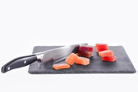 Close up of a delicious looking bits of fruit paste and a kitchen knife on a  Stock Photos