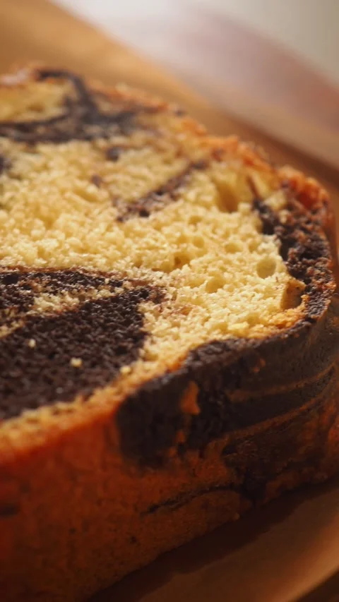 Close-up of a Delicious Marble Cake Slice with Swirl Pattern Stock Footage 332688652