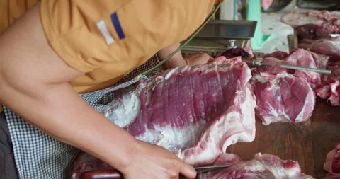 Close-up of a delicious meat display featuring raw pork cuts and sausages from Stock Footage 292910935