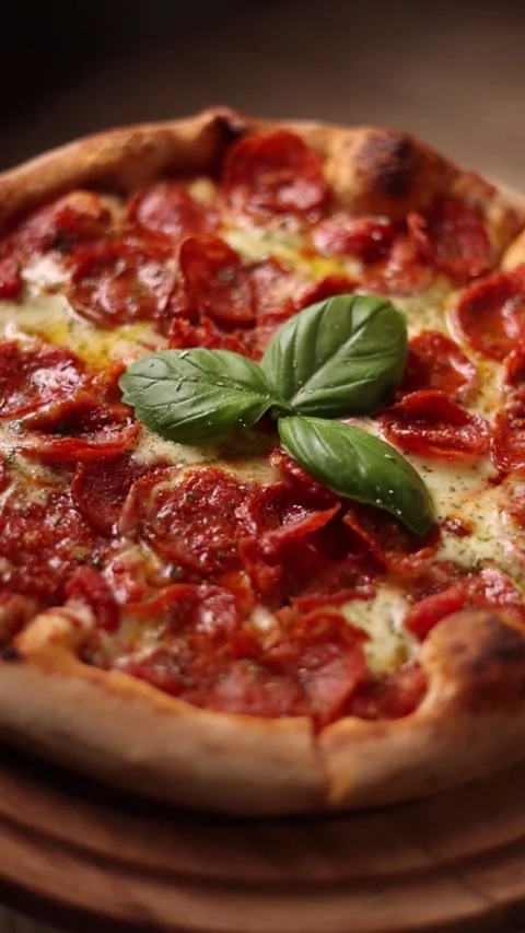 Close up of delicious pepperoni pizza with fresh basil and melted cheese. Stock Footage 345613146
