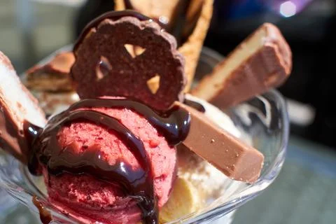 Close-up of a delicious raspberry ice cream sundae decorated with chocolate.. Stock Photos
