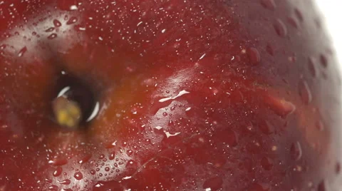 Close-up of a delicious red apple sprinkled with water rotating Stock Footage 60179013