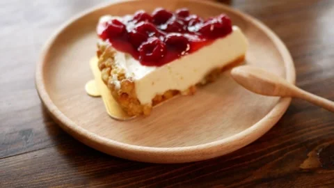Close-up of Delicious Slice of Cherry Cheesecake Graham Cracker Crust Video stock 328536338