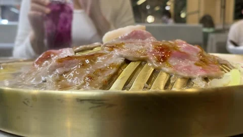 Close up delicious Thai style raw meat barbecue grilled buffet golden heat pan Stock Footage 251564828