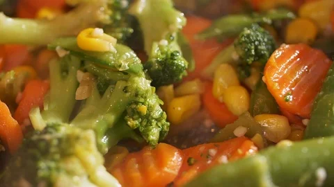 Close-up of delicious vegetables being cooked in the frying pan. Stock Footage 107437457