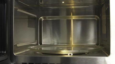 Close up of demonstrating the space inside the empty microwave oven. Household 스톡 사진