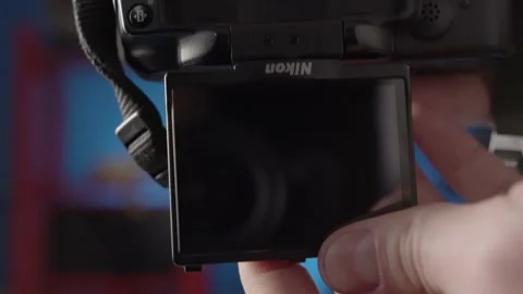 Close-up demonstration of opening the viewfinder screen on the camera. Stock Footage 234541461